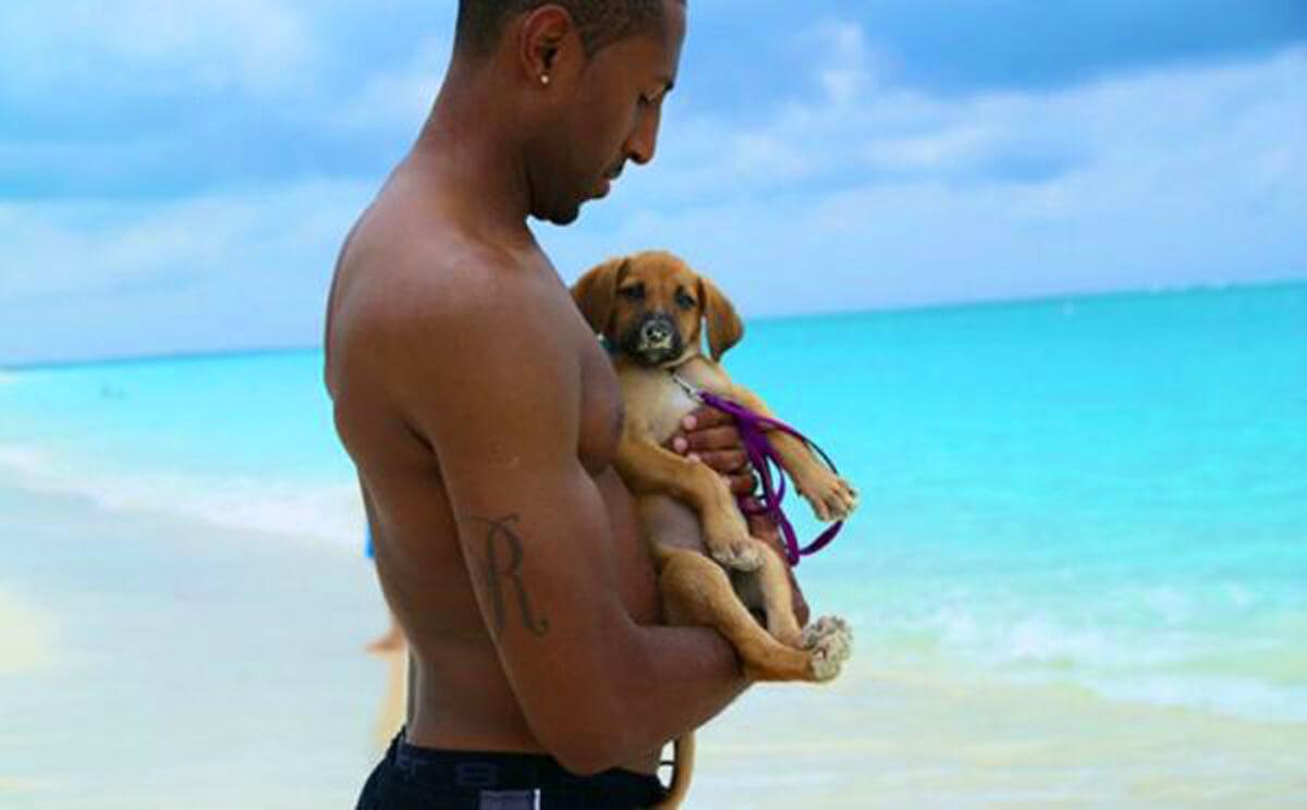 man holding puppy in Turks and Caicos