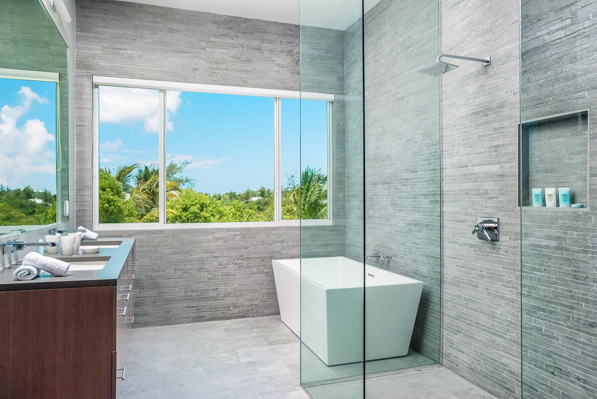 En suite bath with a soaking tub and rain head shower 