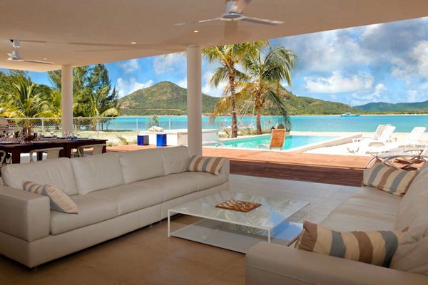 Relax on the covered patio with beach and harbor views