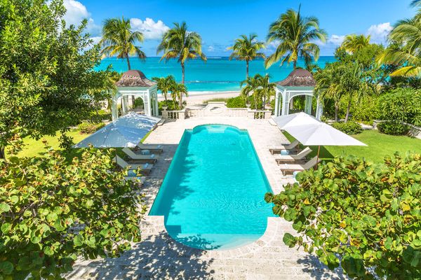 The luxury pool at Coral Pavilion Villa sits just a few yard from the beautiful Grace Bay Beach