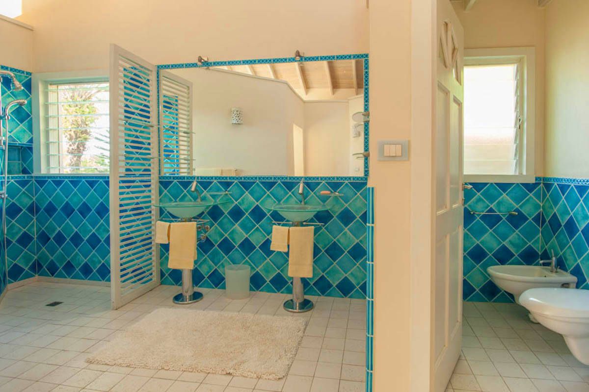 En suite bath with dual sinks and a shower