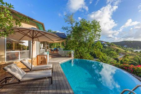The infinity edge pool at Galley Bay Heights #001 over looks the hillside at Galley Bay