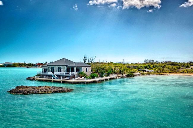 Rock Spray Villa sits on the water's edge on Chalk Sound