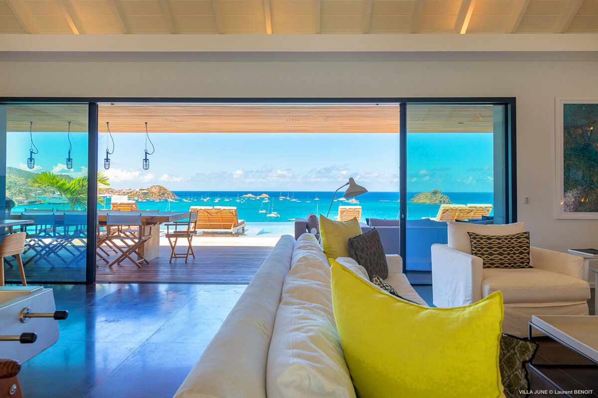 The living area opens to the deck through a large set of glass doors