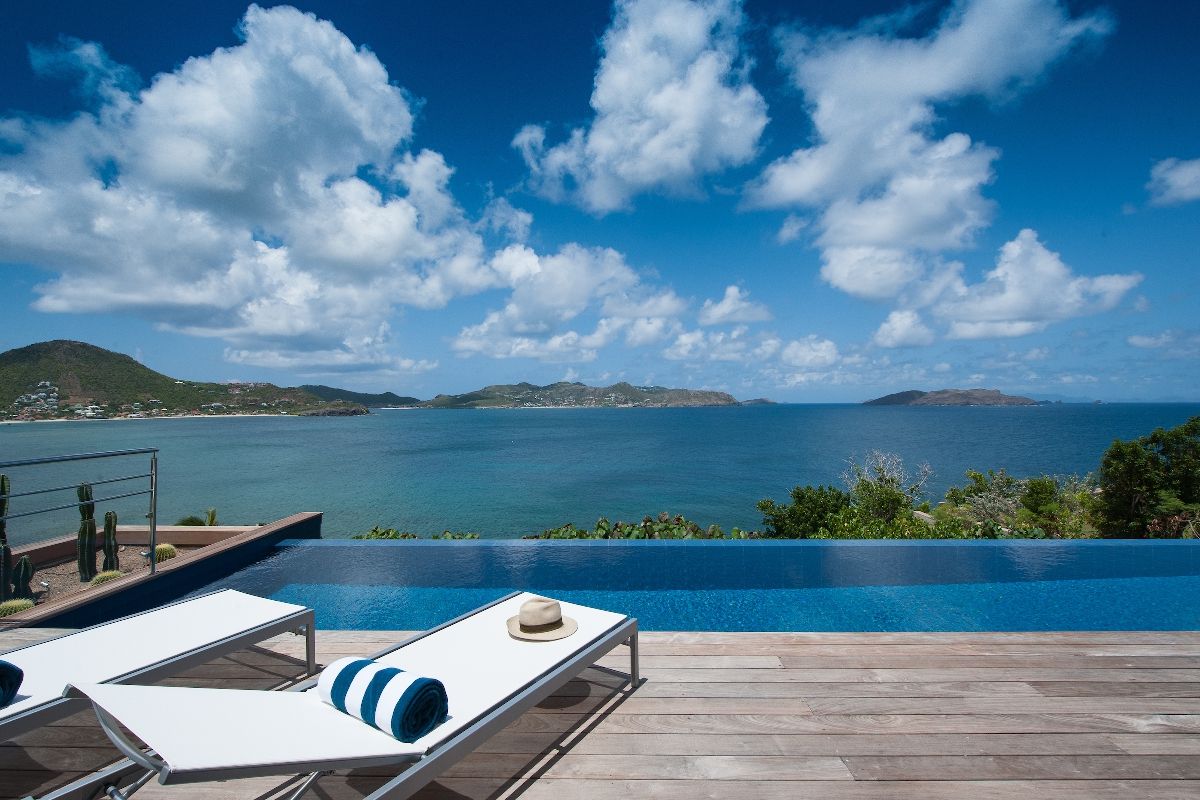 Lounge by the pool while enjoying amazing ocean views and over to St. Jean Bay