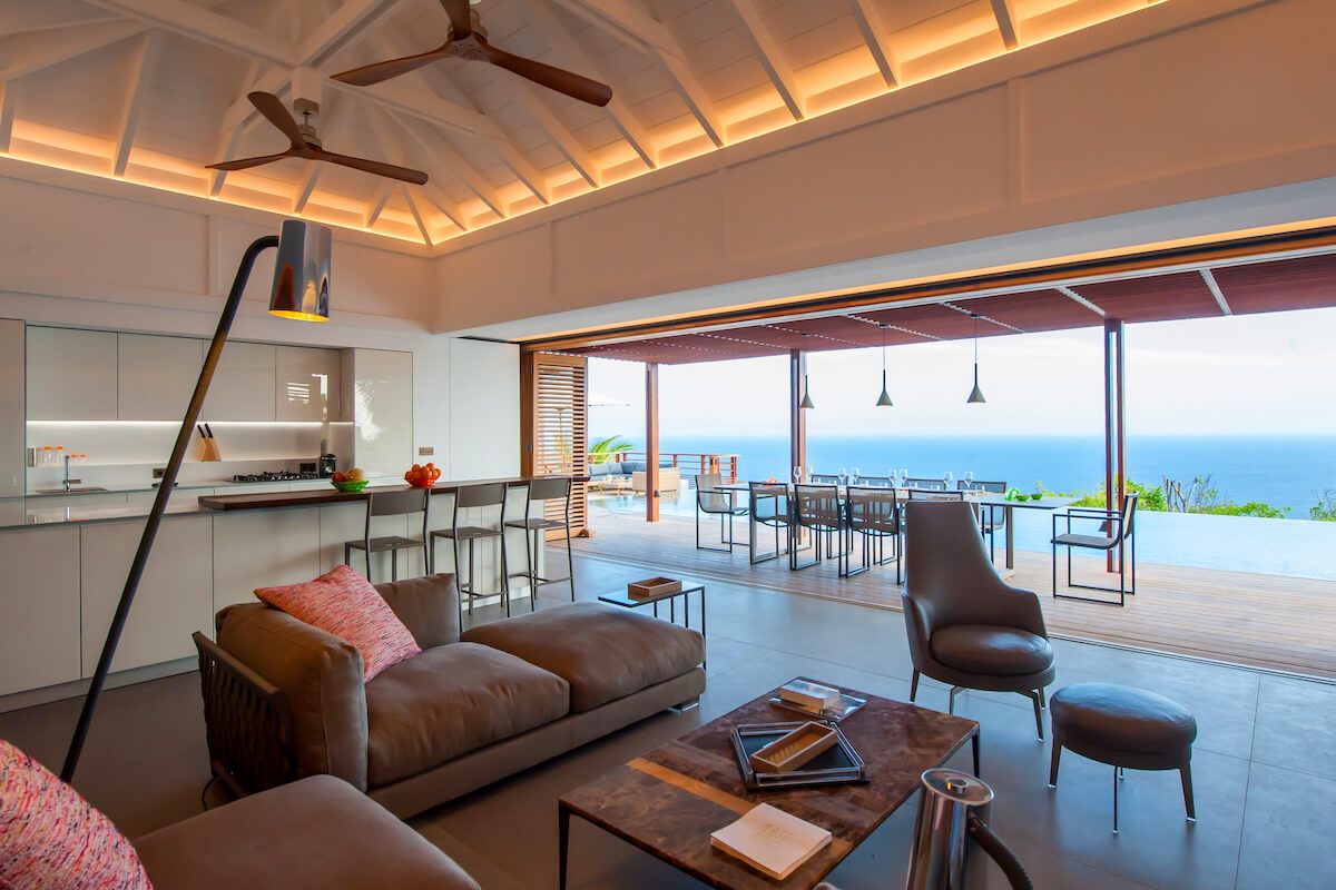 Living space opens to the outdoors through large glass doors