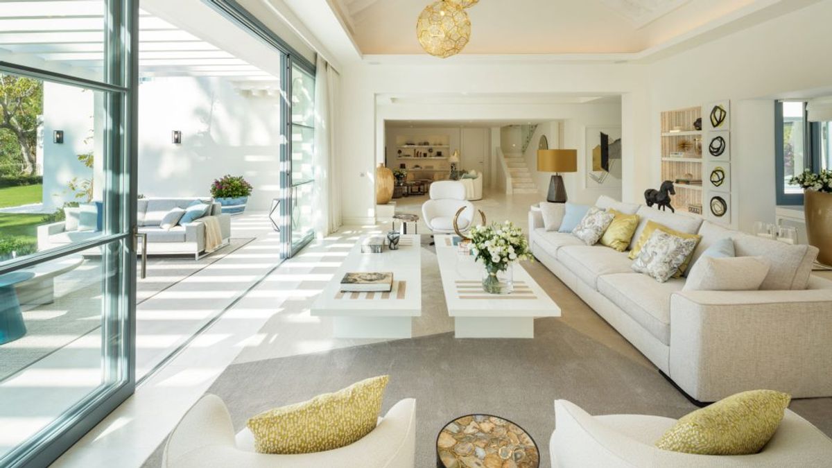Elegant living room with plush sofas, flooded with natural light.