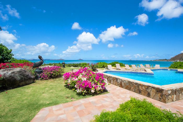 Sandcastle Villa is located directly on Mahoe Bay Beach