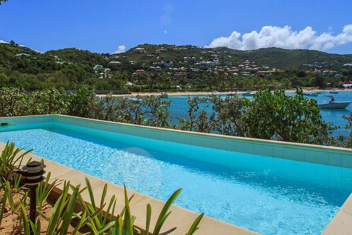 Sous La Falaise Villa sits above the edge of beautiful St. Jean Bay