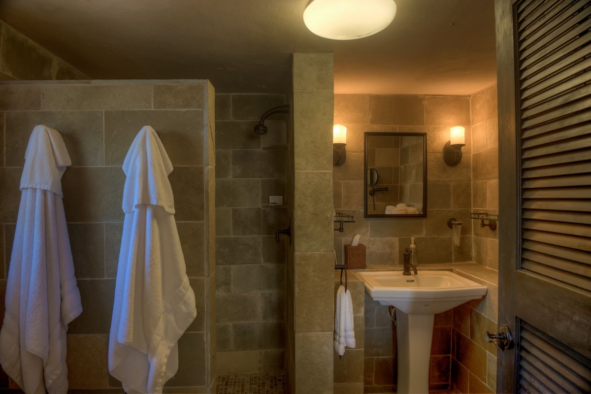 En suite bathroom with a single vanity and shower