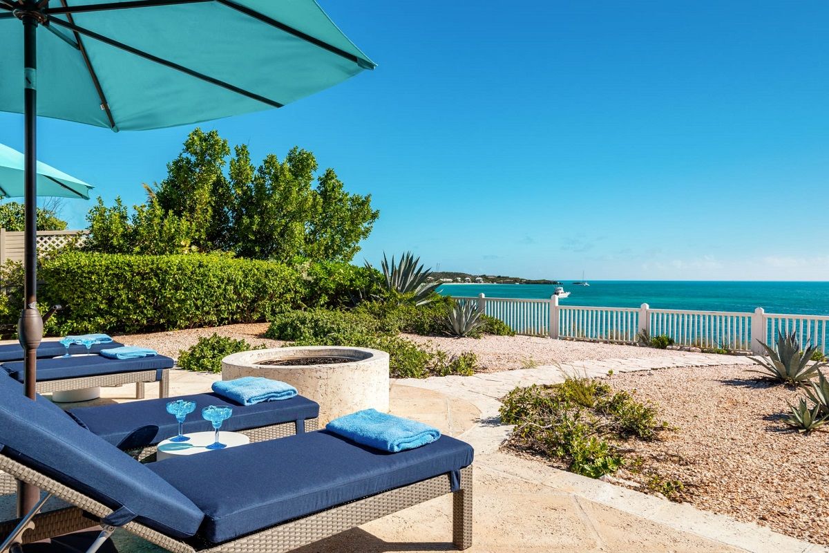 Loungers facing the bay and a pathway to the sun dock
