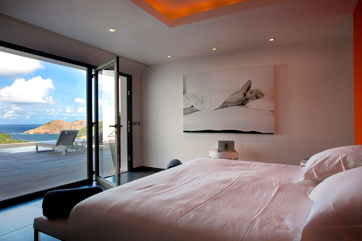 Bedroom opens to ocean views from the lower level balcony