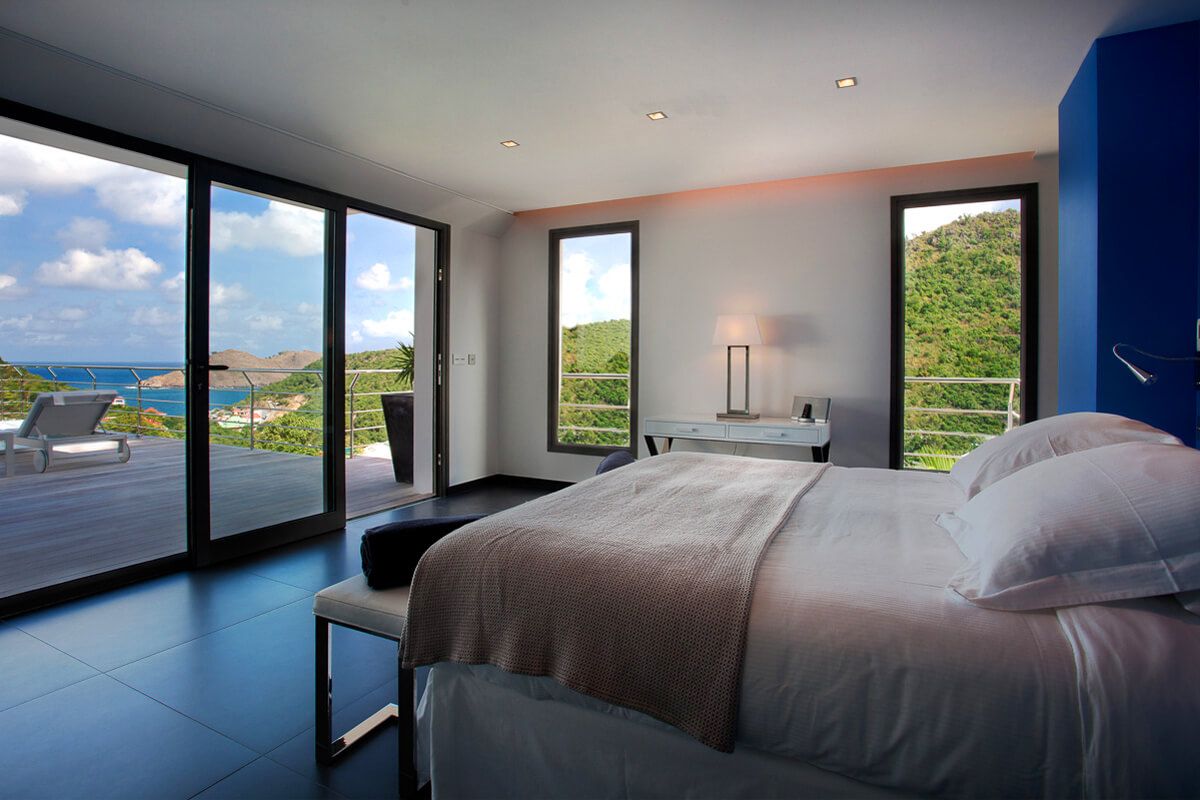 Bedroom opens to ocean views from the lower level balcony