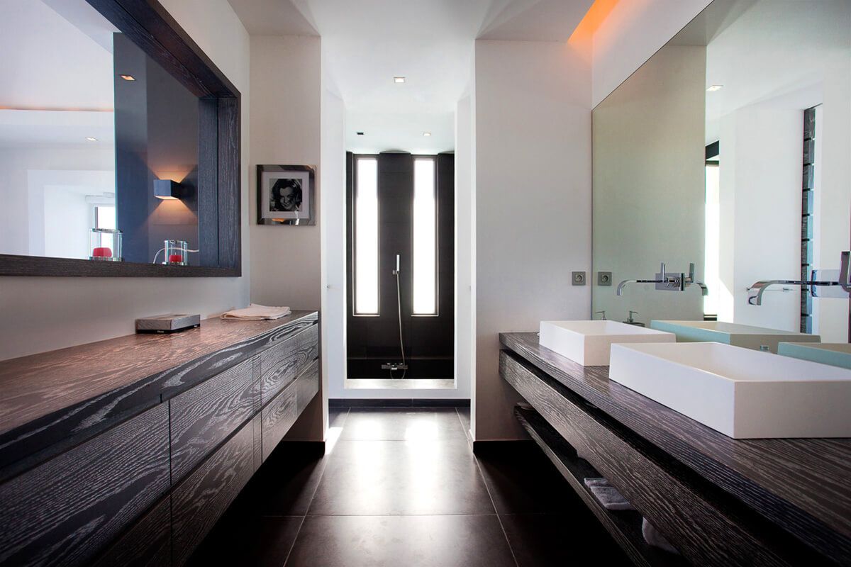 A double vanity en suite bathroom with a shower