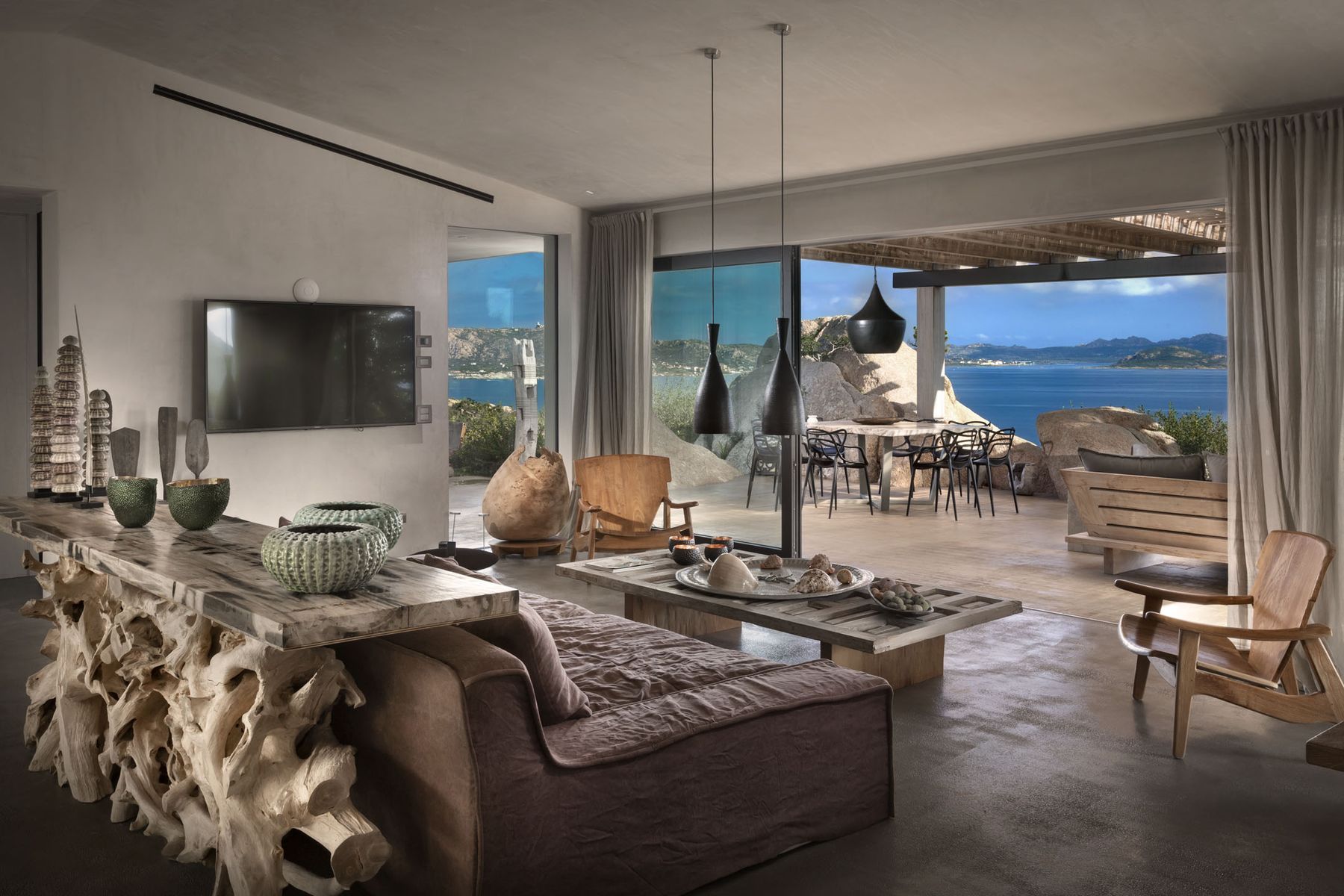 Contemporary open-plan living with floor-to-ceiling windows, blurring the lines between indoor and outdoor living.