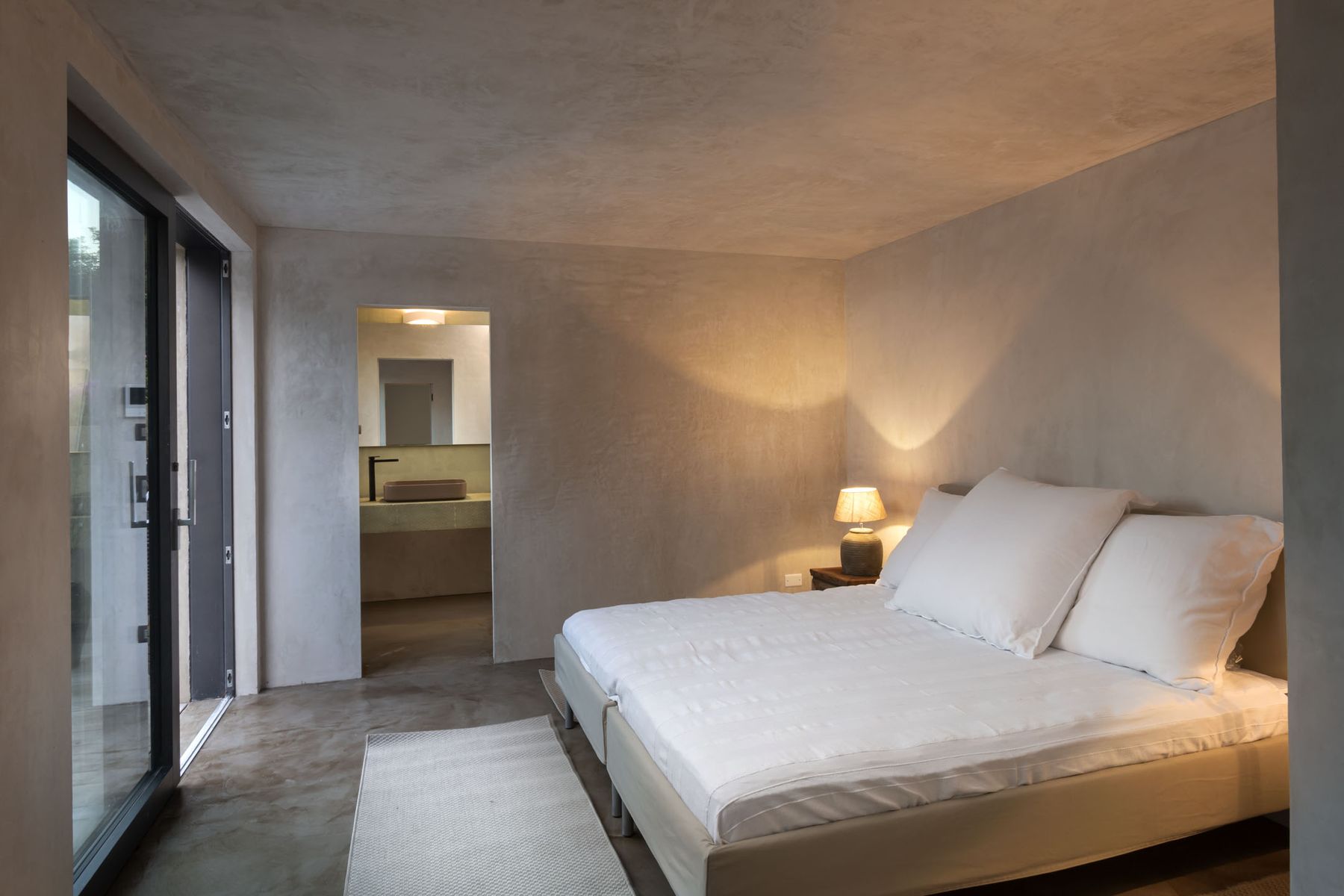 Double ensuite bedroom, with contemporary furnishings and outdoor access.