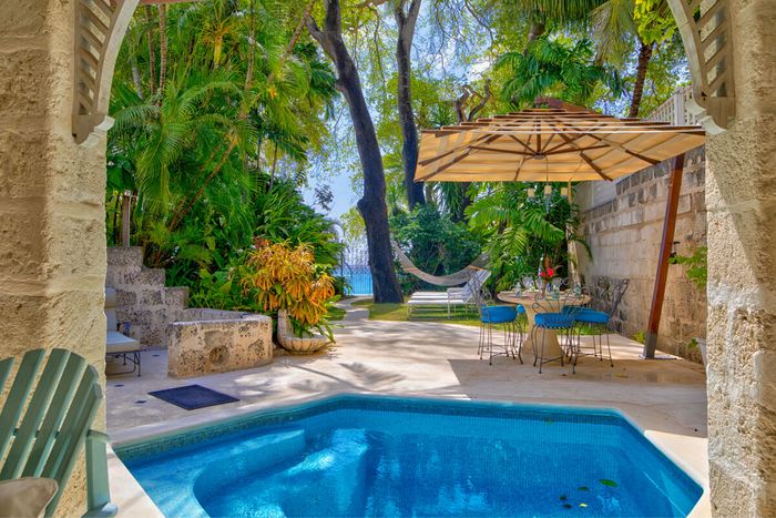 Plunge pool and gardens leading to the beach at Waverly Villa