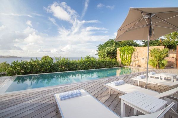 Lounge by the pool at Marie Villa and enjoy views of the ocean