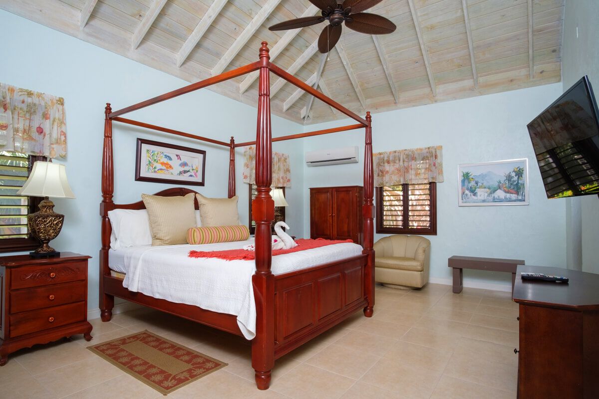 Oleander Suite king bed in the garden cottage
