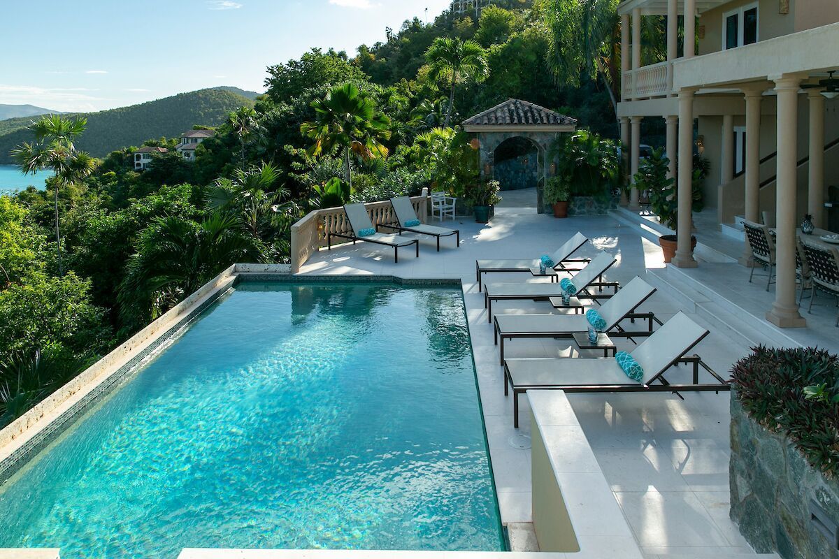 Beautiful villa exterior surrounded by landscaped gardens and lush greenery.