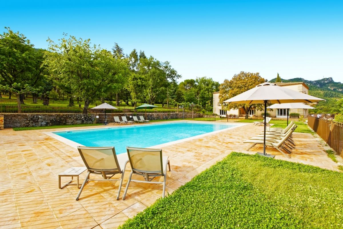 Large pool with lounge chairs and umbrellas