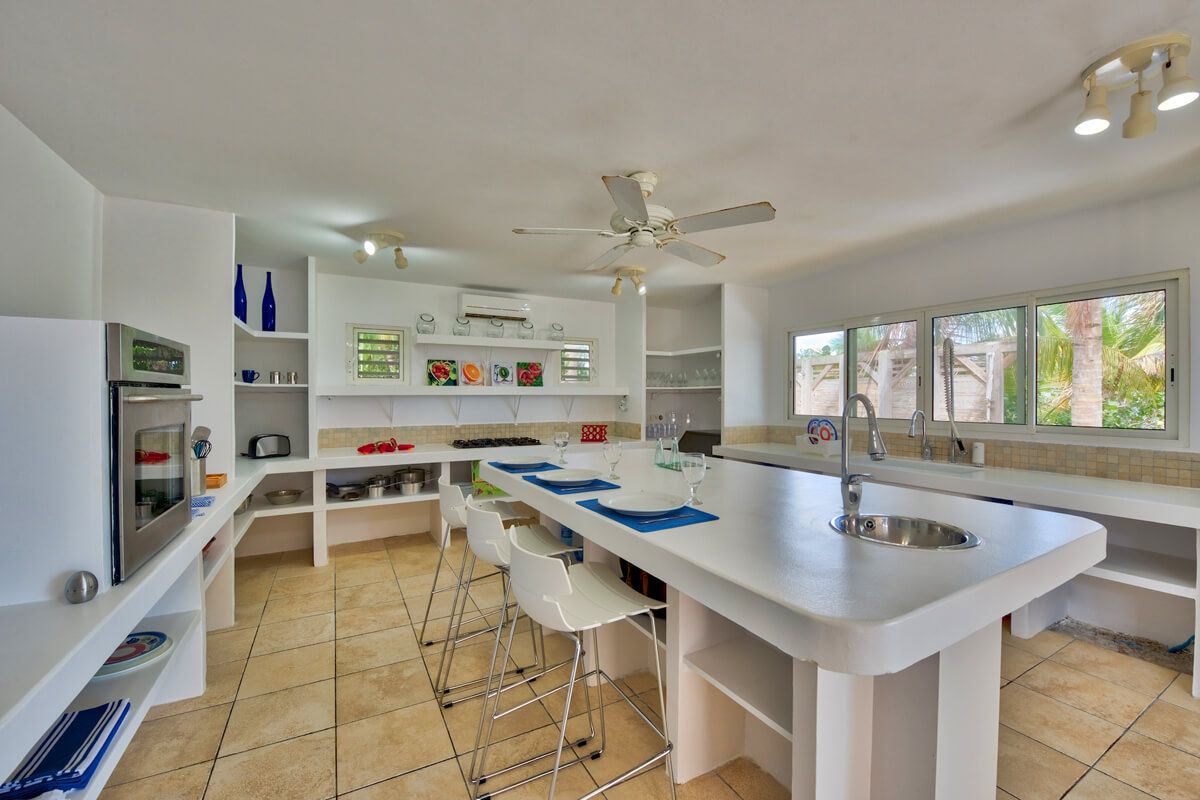 The kitchen island with a breakfast bar that seats three