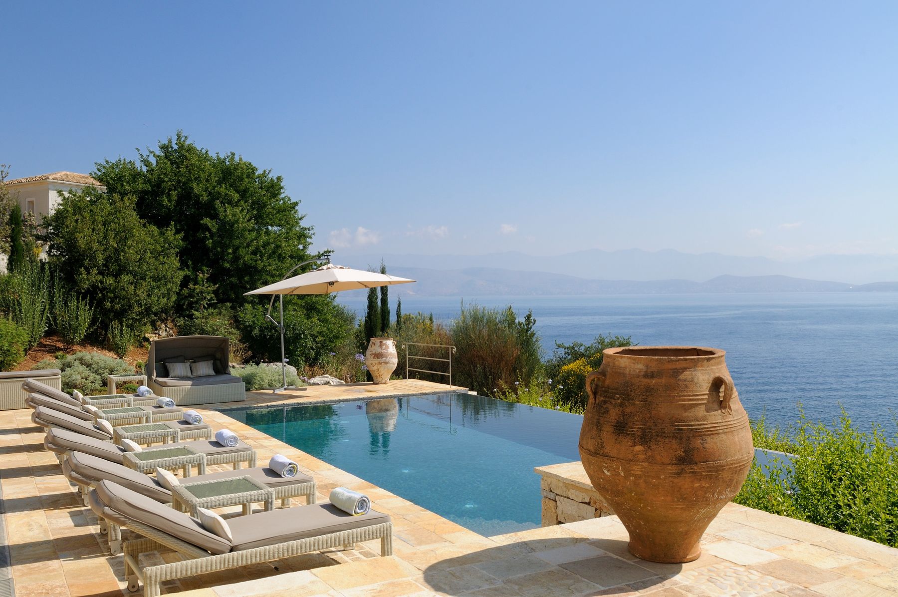 The private infinity pool offers breathtaking sea vistas and is lined with loungers and sun beds.