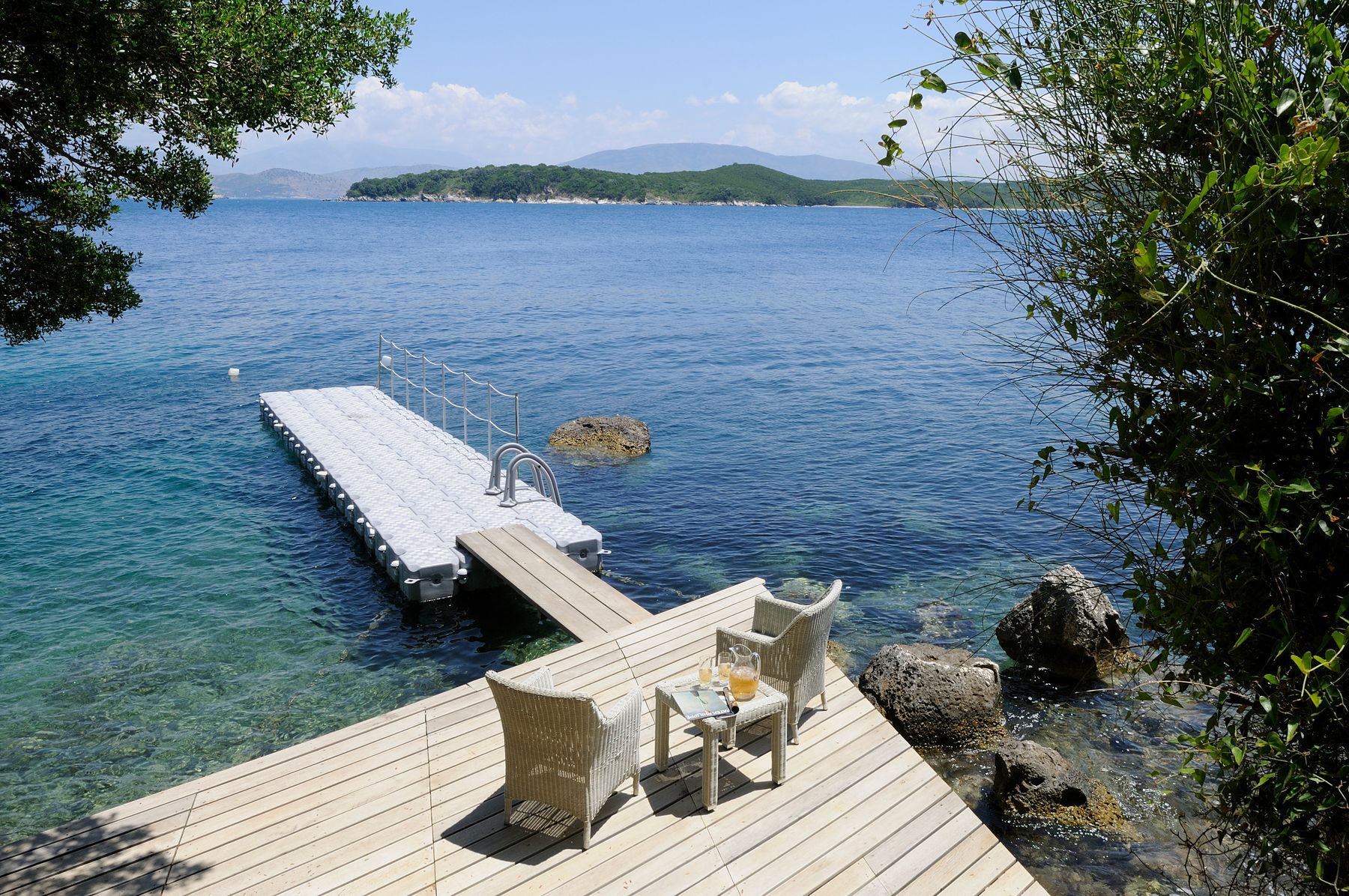 Descend the stone pathway from the pool terrace leading you to a private pebble bay and a shared dock.