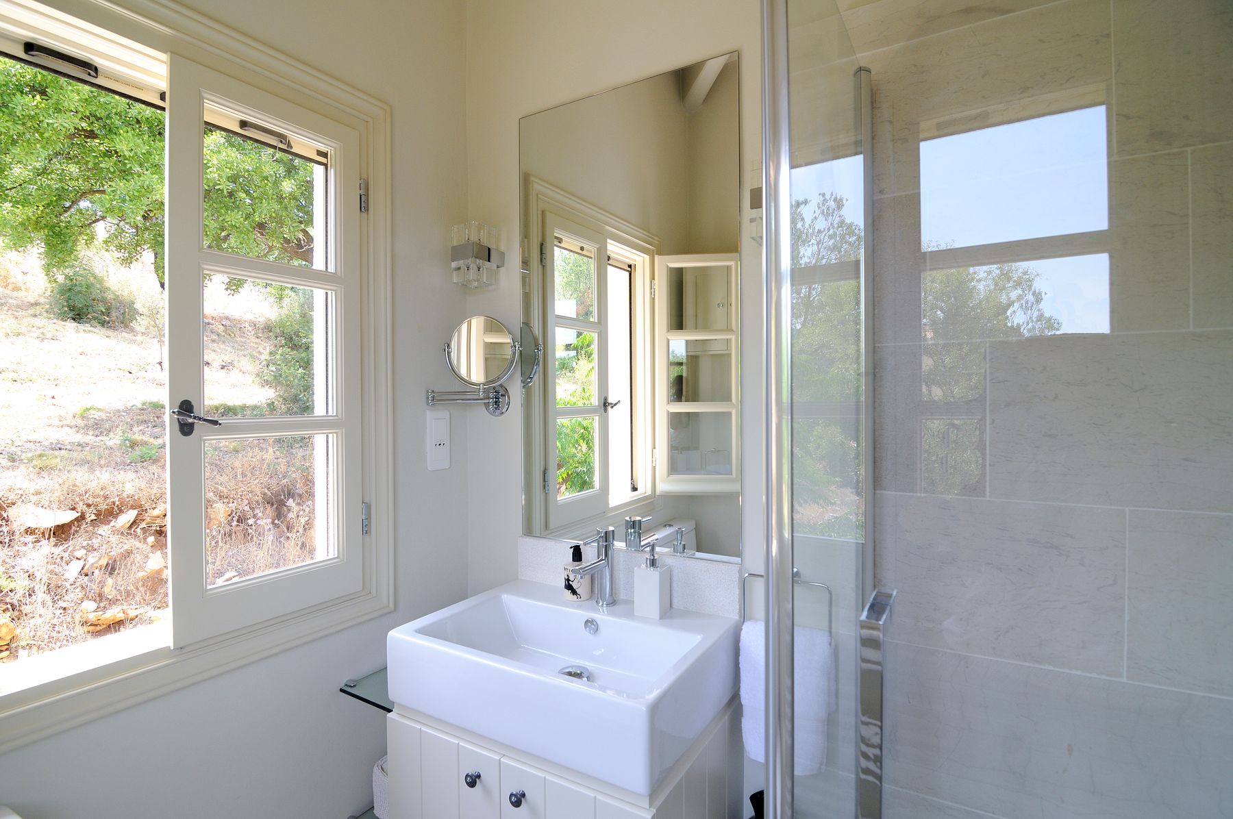 Ensuite bathroom with walk-in shower, and modern basin and vanity unit.