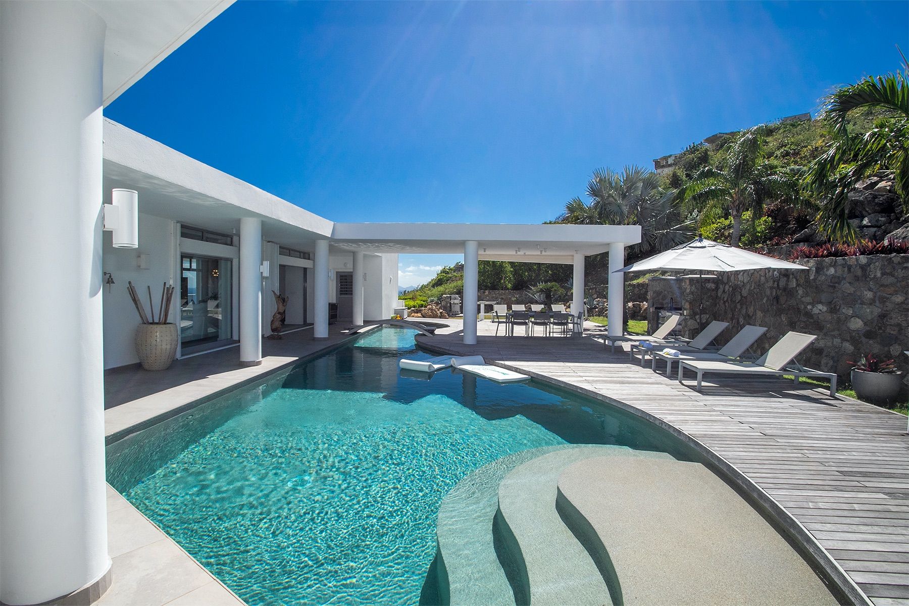 Swimming pool with adjacent loungers