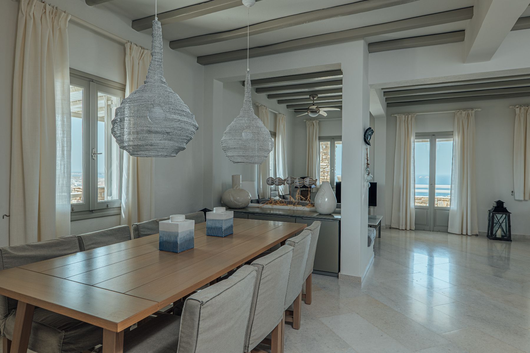 Bright with modern furnishings, this dining area has seating for eight guests, and access to the veranda.

