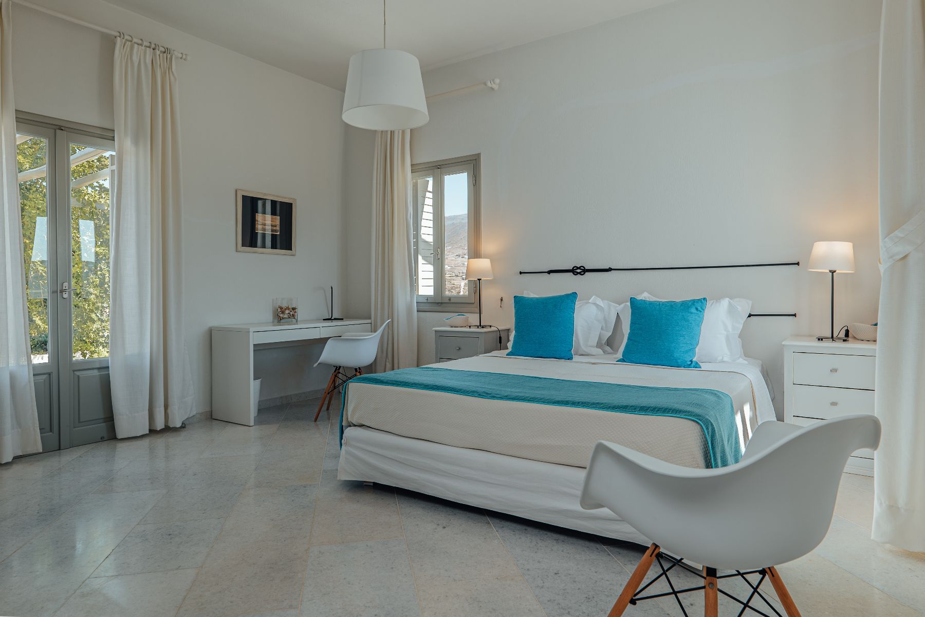 Light and spacious double ensuite bedroom, with desk and flat-screen television.