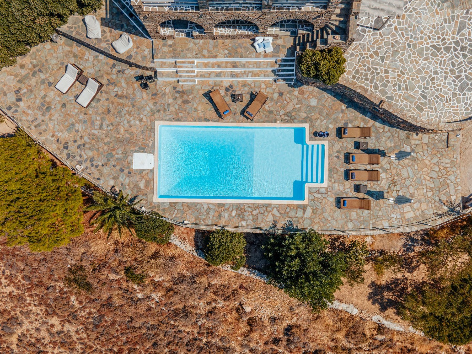 Expansive pool terrace with sparkling swimming pool, perfect for cooling off in the Greek sunshine. 
