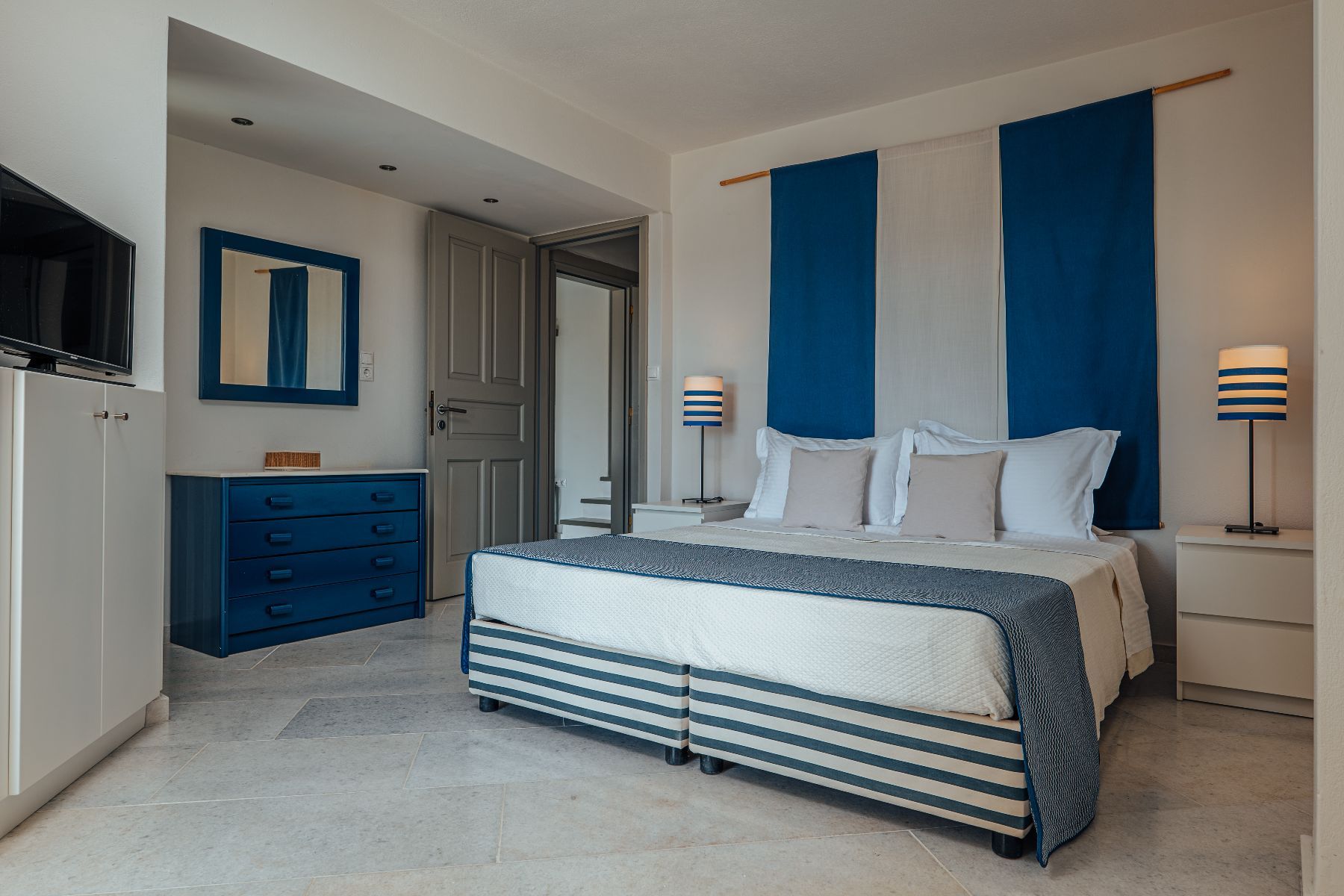 Double ensuite bedroom with flat-screen television.