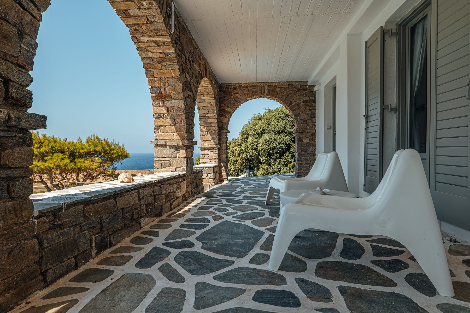 Private stone terraces with plenty of shade, and sweeping sea views. 