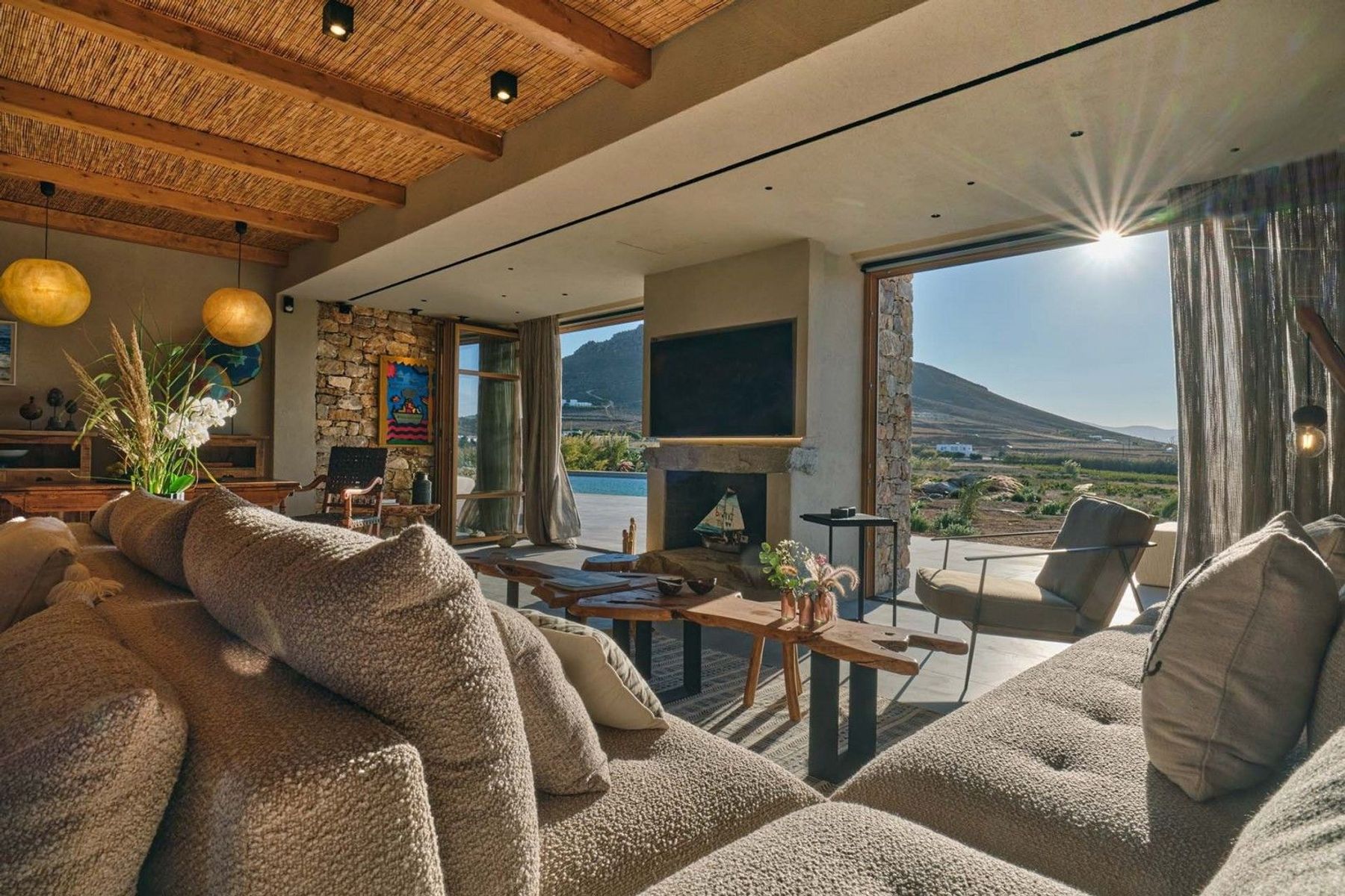 Open-plan bright living area with large doors that let the soothing sunlight in and blur the limits between interiors and outdoors.