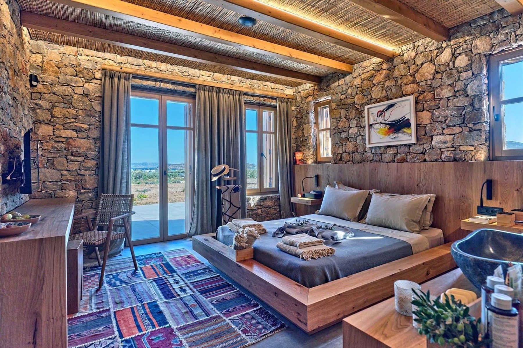 Double ensuite bedroom with television, and access to the pool terrace.