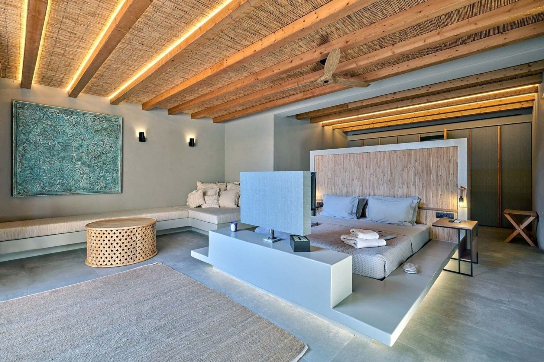 Double ensuite bedroom with television and contemporary furnishings. 