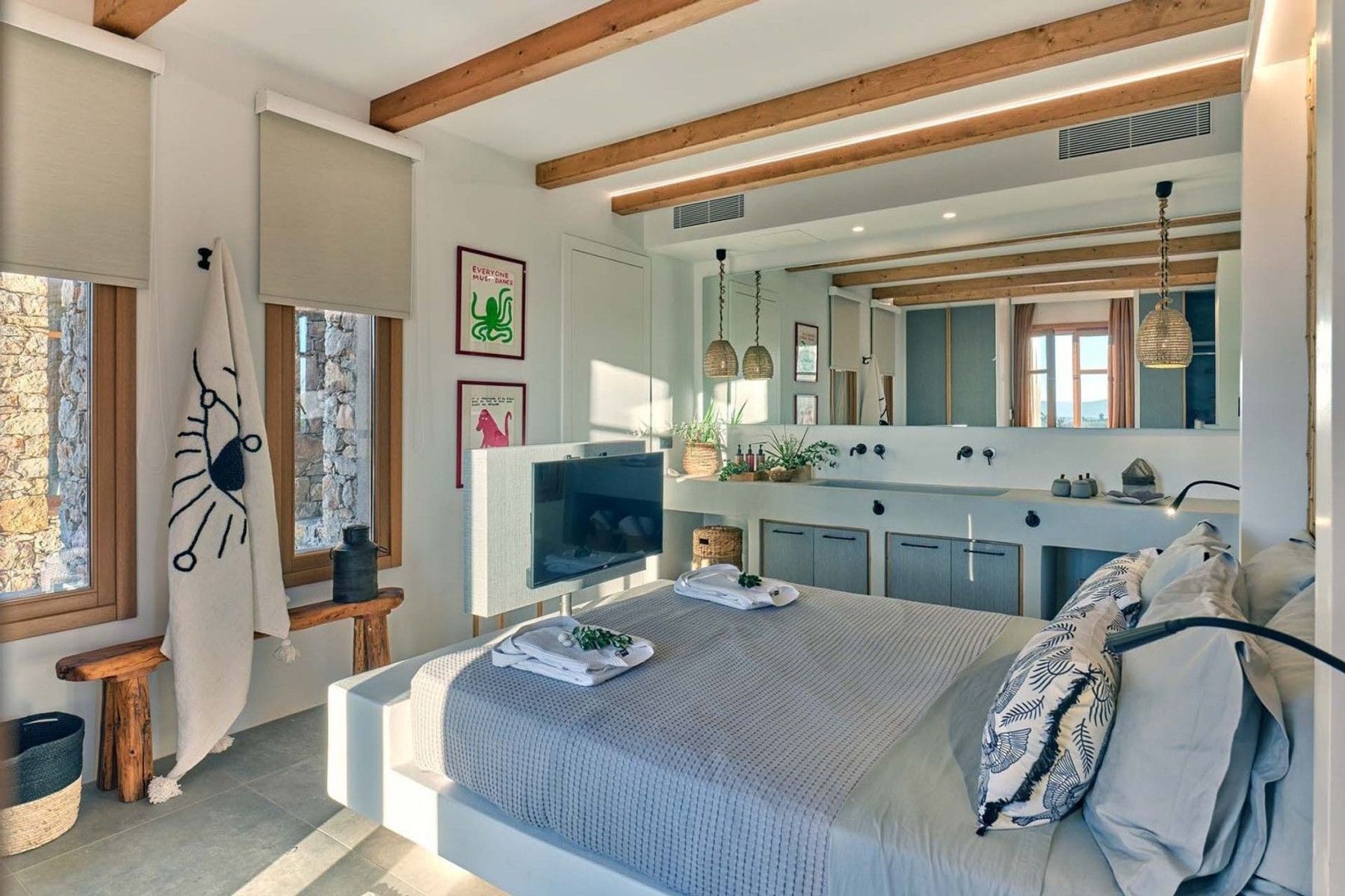 Double ensuite bedroom with television, double basins, and modern vanity unit.