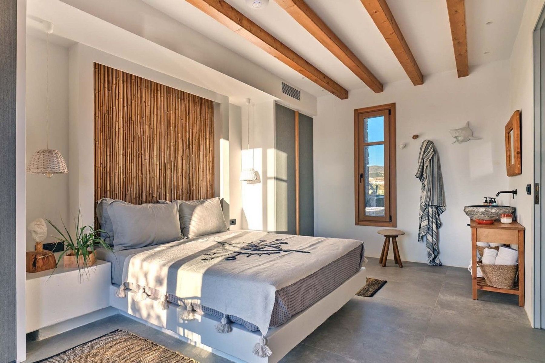 Bright and airy double ensuite bedroom with shower and separate basin with modern vanity unit. 