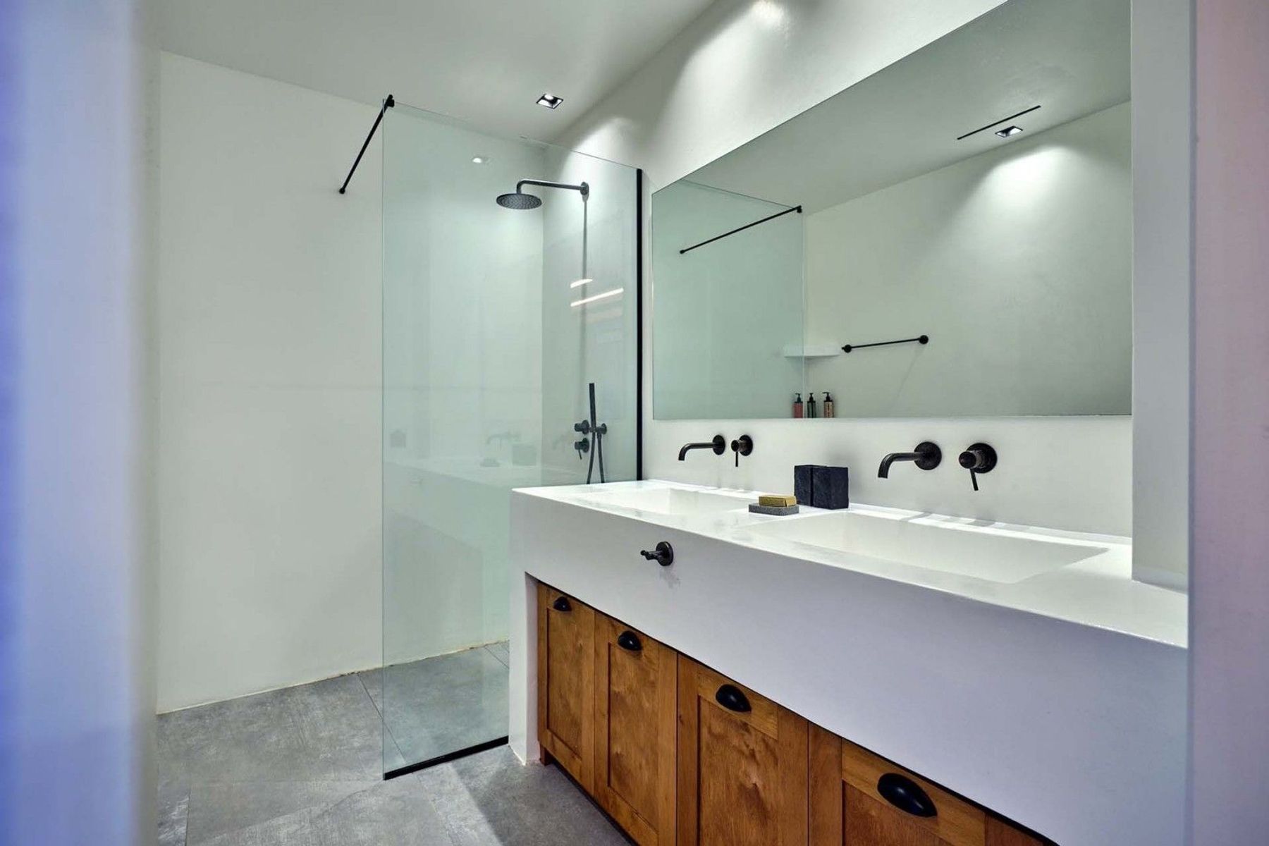 Ensuite bathroom with spacious walk-in shower, double basins and modern vanity units. 
