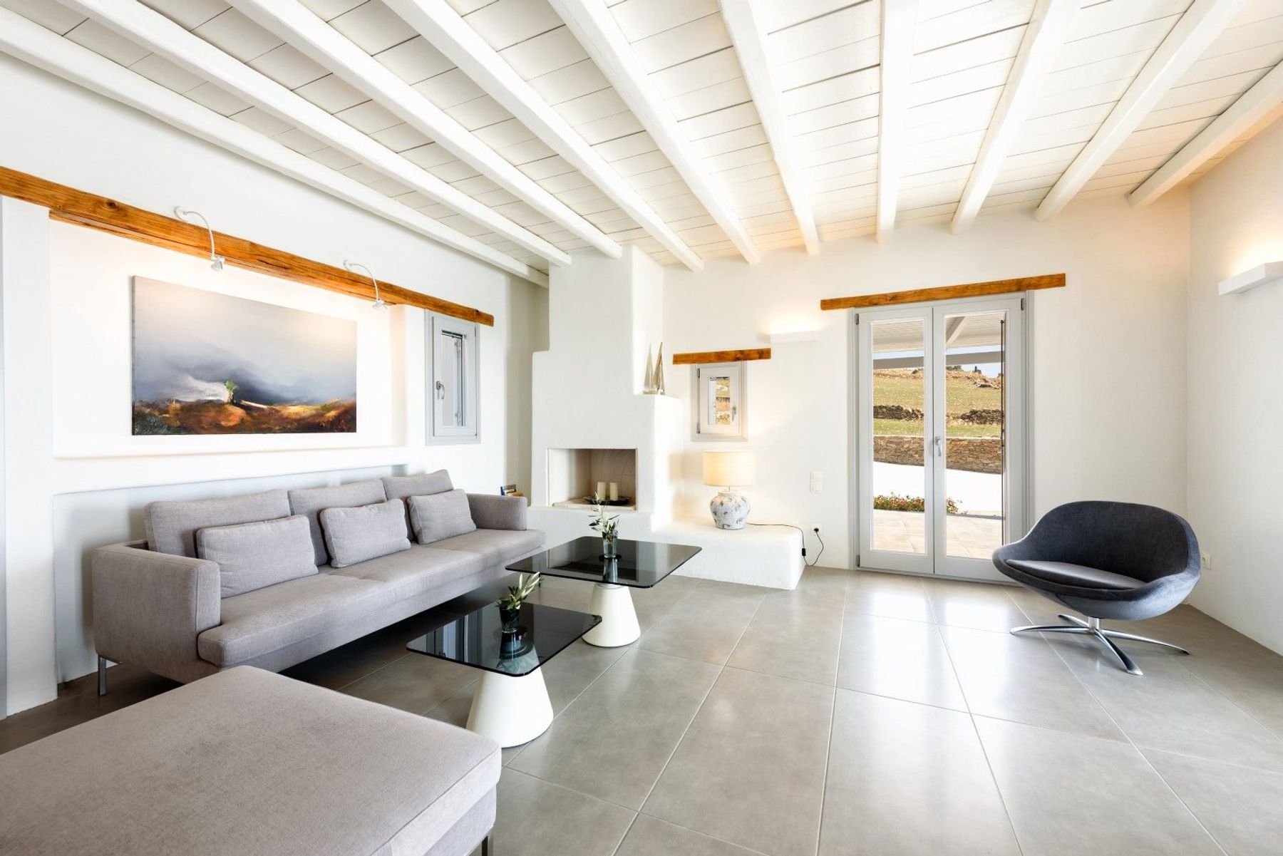 The modern white-washed living room is the perfect space to relax. 