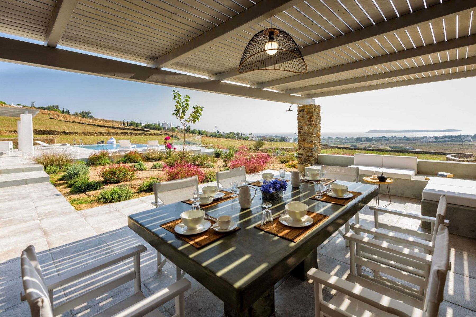 Alfresco dining under the pergola with seating for six guests.