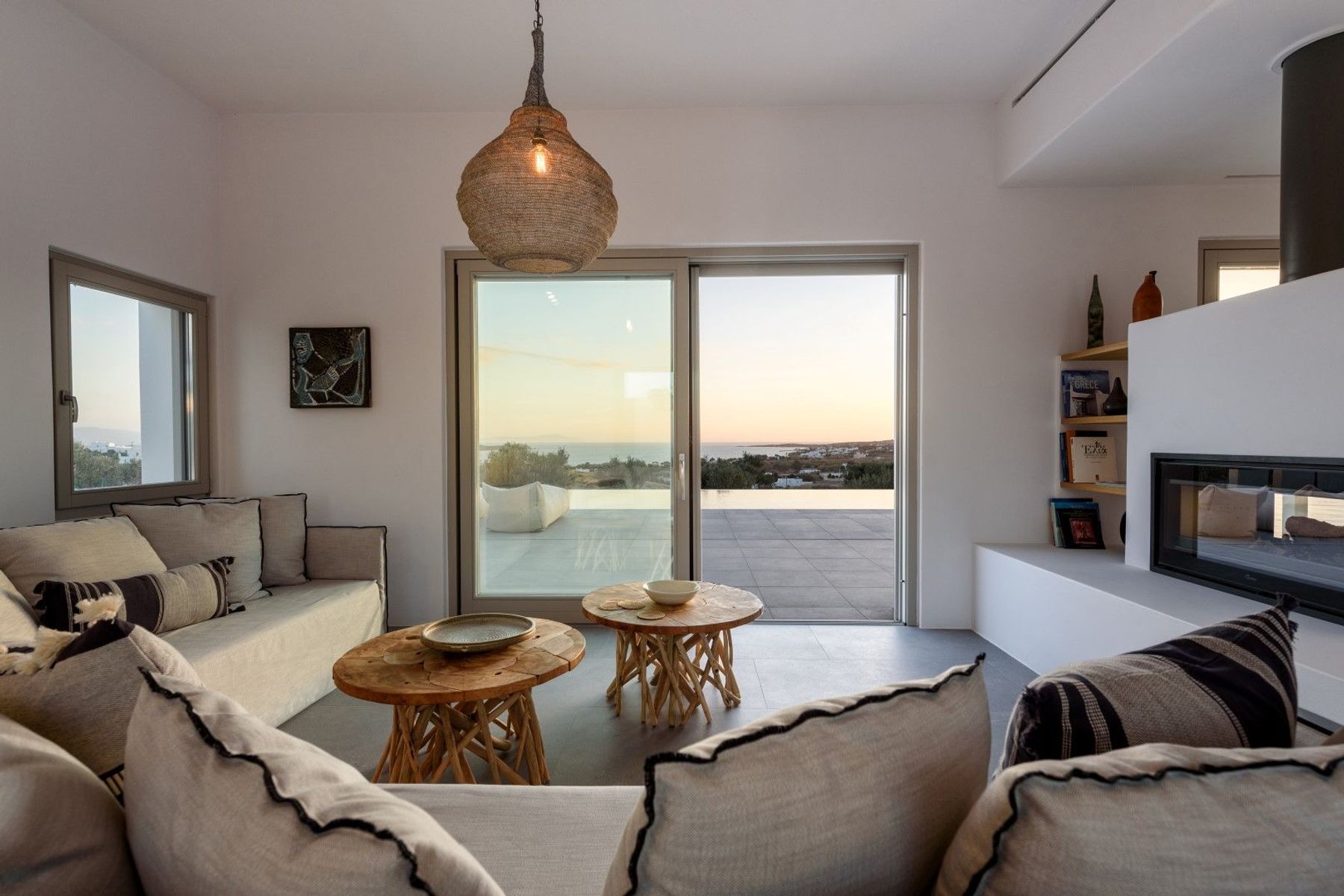 Floor-to-ceiling windows in the stunning living room, where you can admire stunning sunset views.