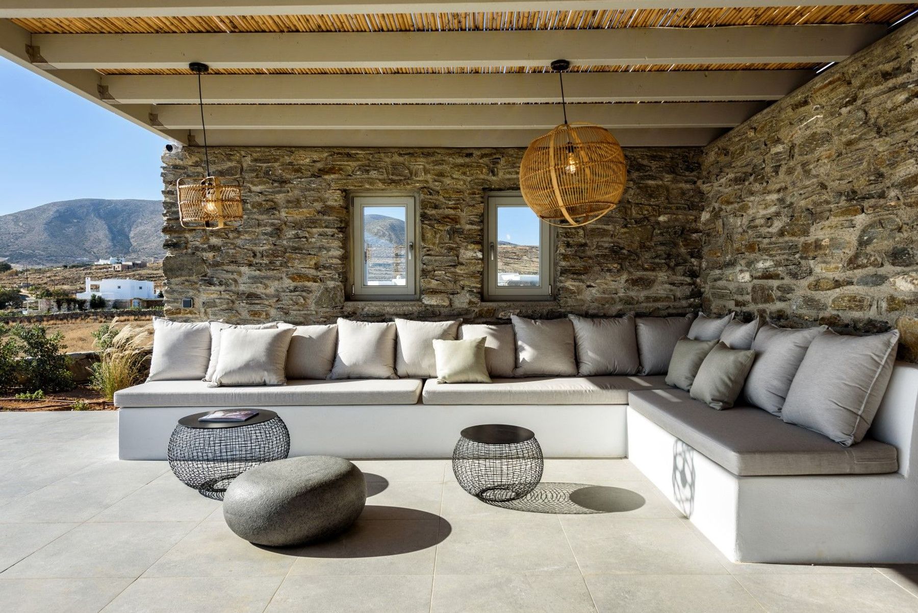 Shaded outdoor lounge space under a charming pergola.