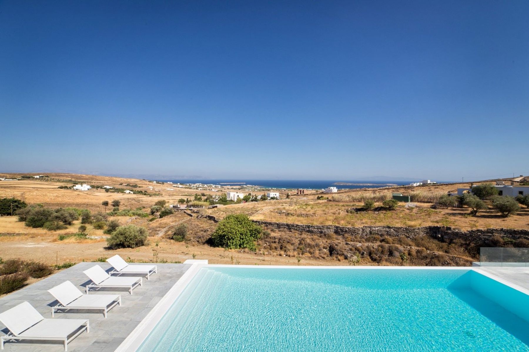 The large swimming pool, overlooks the beautiful Golden Beach and the nearby islands of the stunning Aegean Sea.