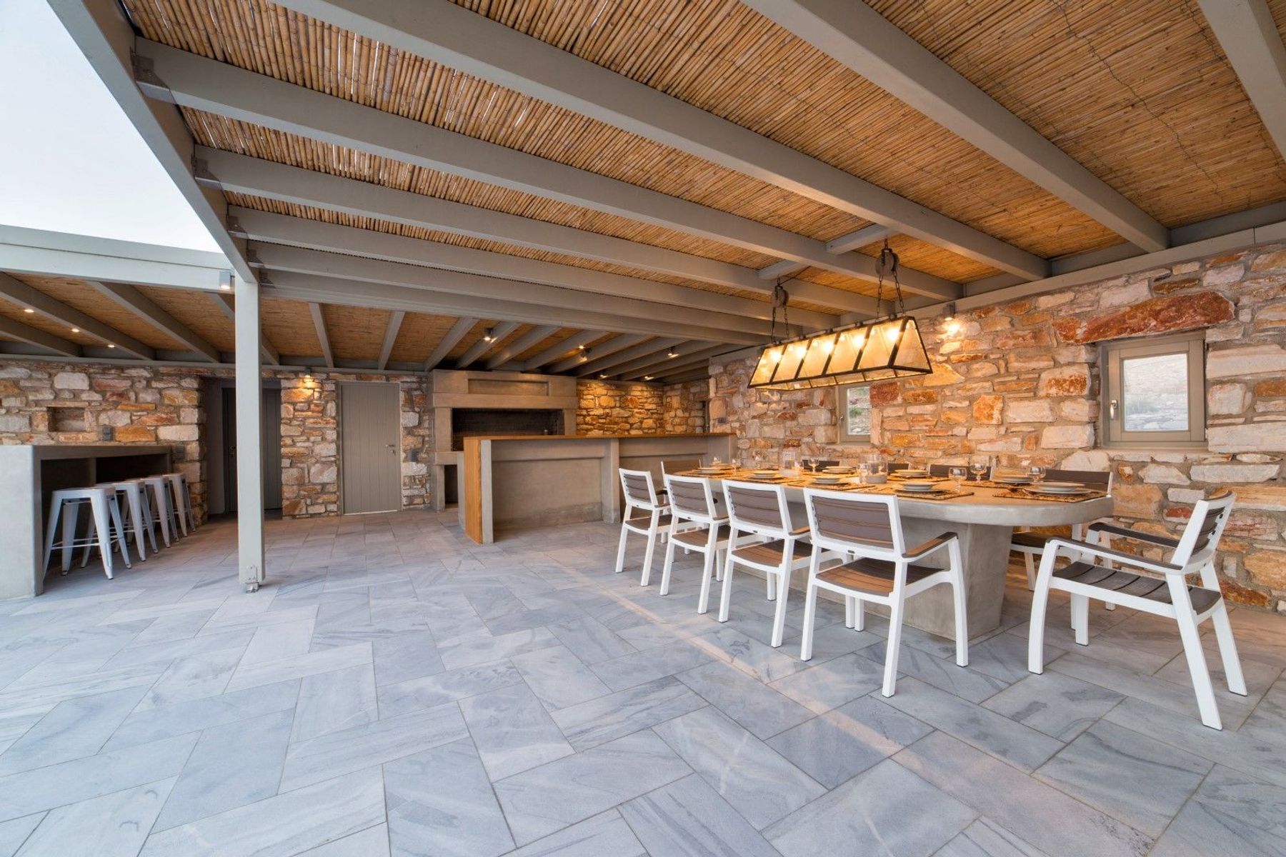 Spacious shaded dining area adjacent to the BBQ facilities. The large table seats up to ten guests.