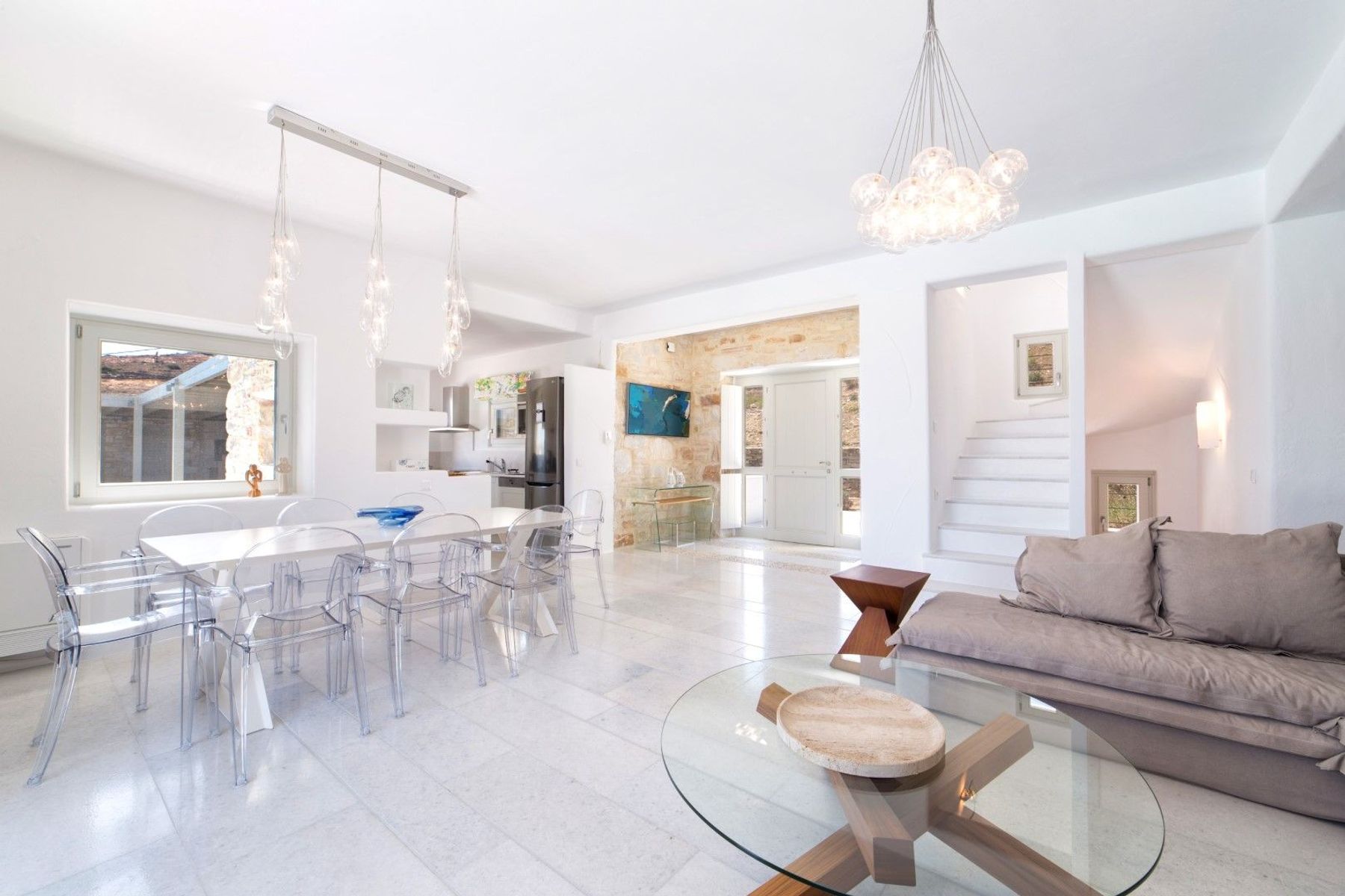 Charming chandeliers illuminating the dining area, which seats up to eight people.