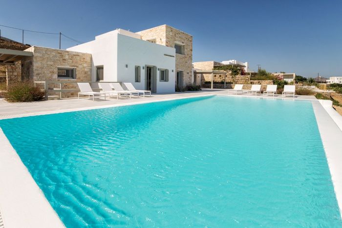 Modern luxury villa with large private swimming pool, built in an Cycladic style.