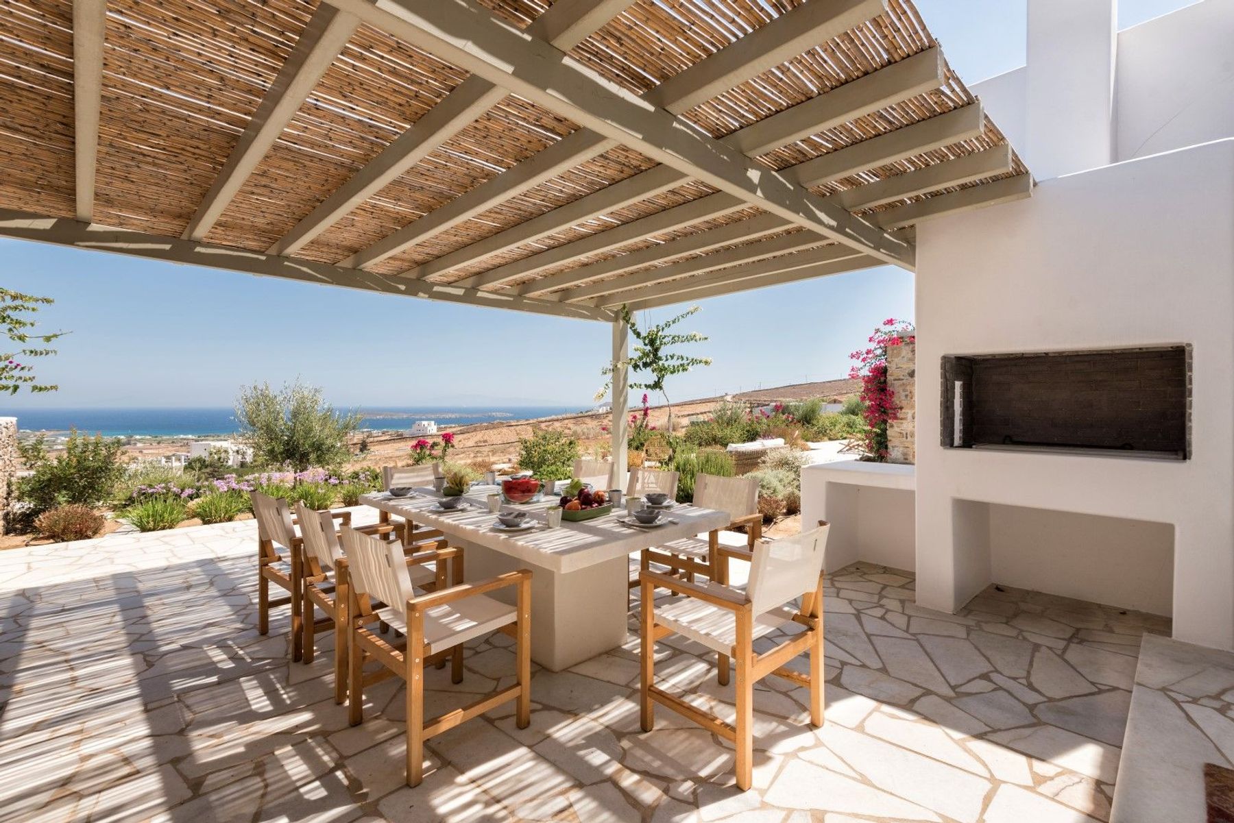 Spacious outdoor seating area, shaded by a pergola. Dine alfresco with a table seating up to eight guests,